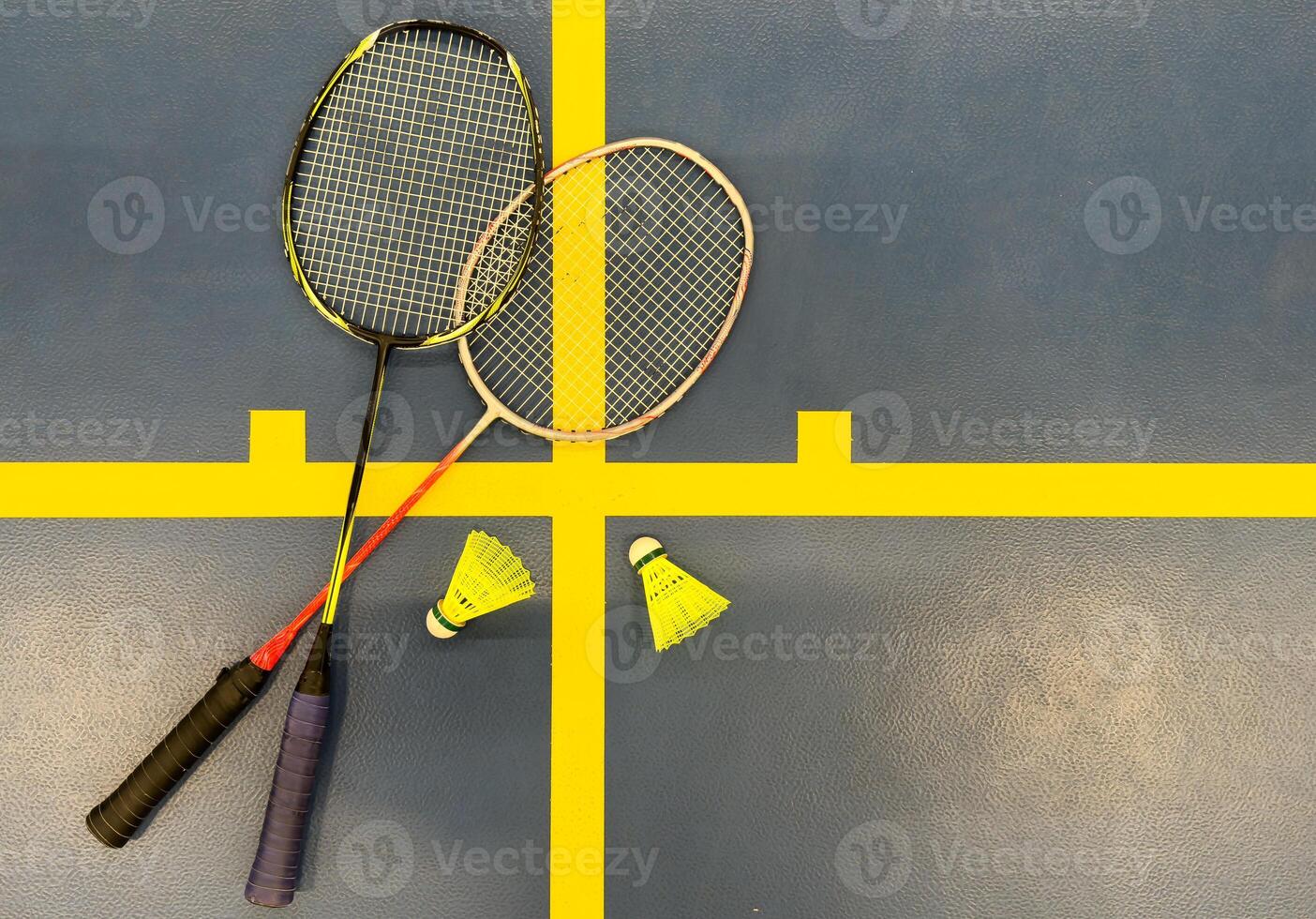 Shuttlecock on badminton racquet on floor. photo