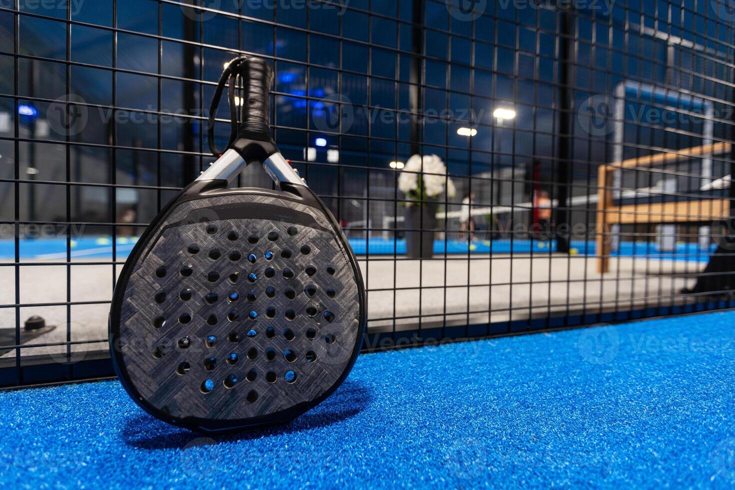 paddle tennis racket and balls on court, photo