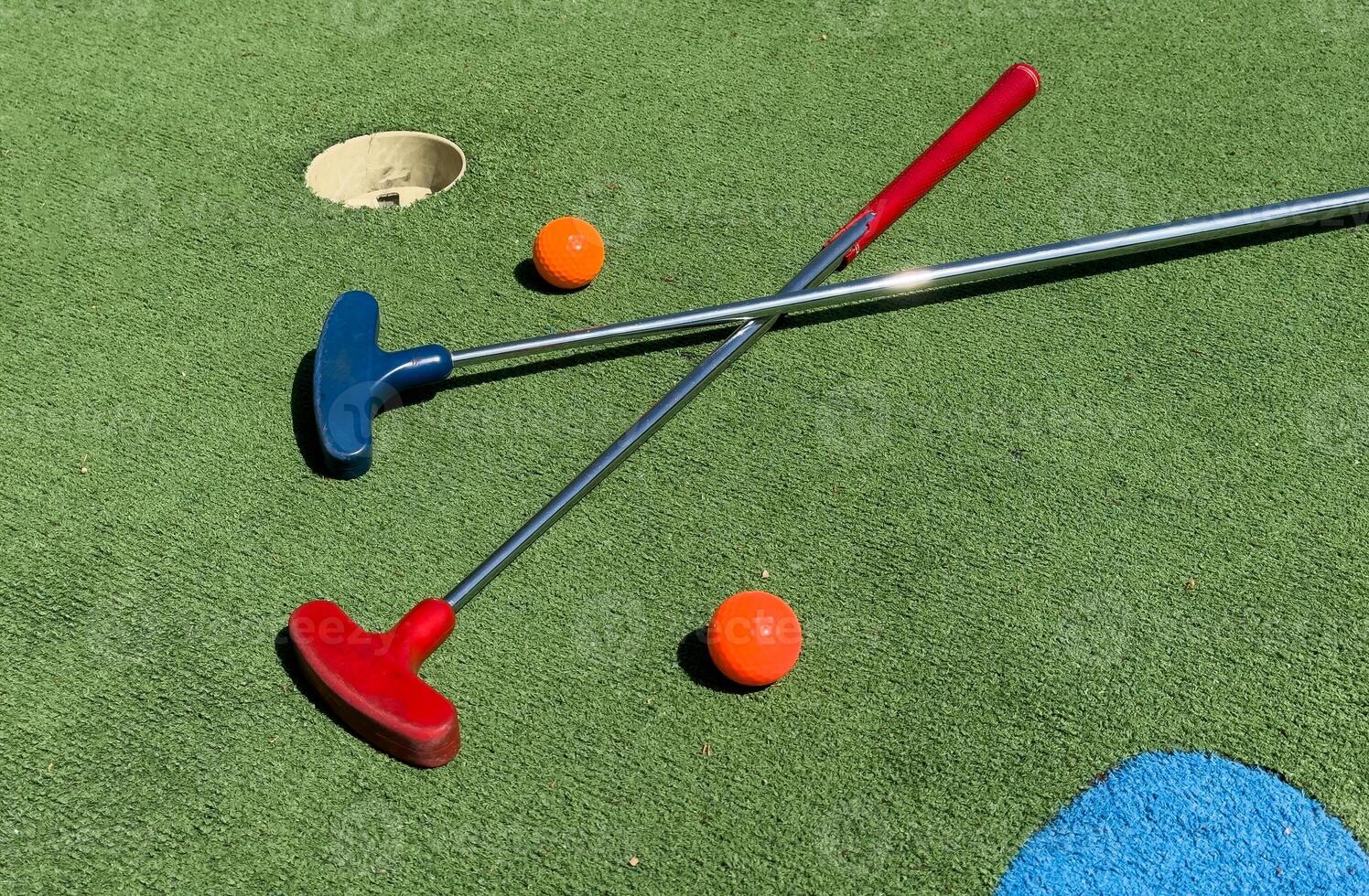 Closeup of player play mini golf with ball photo