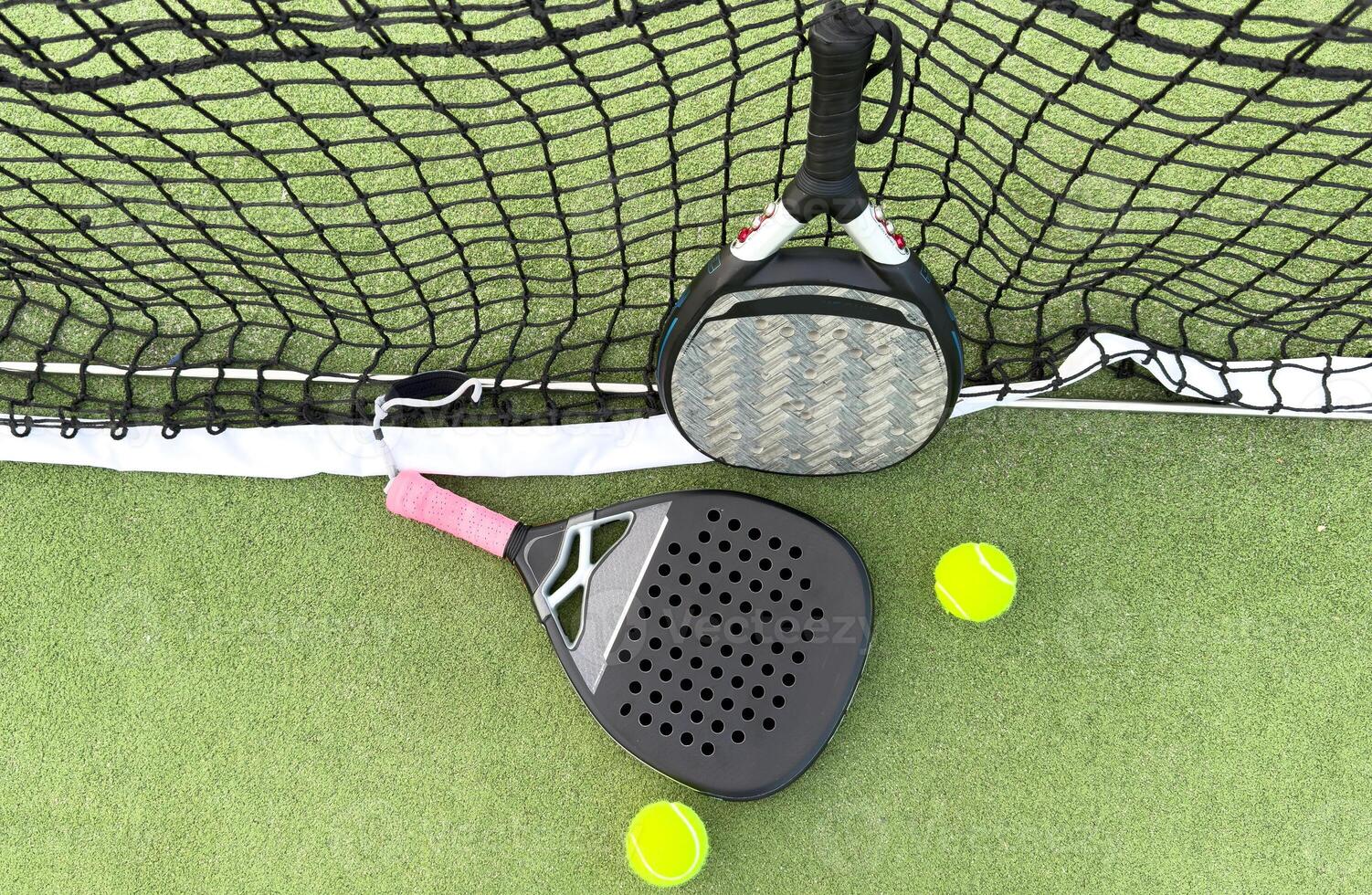 Paddle tennis objects on grass court photo