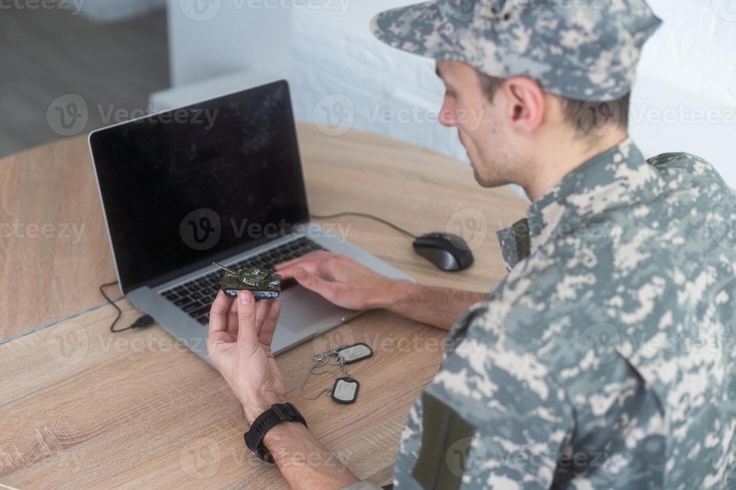 military man holding a model tank photo