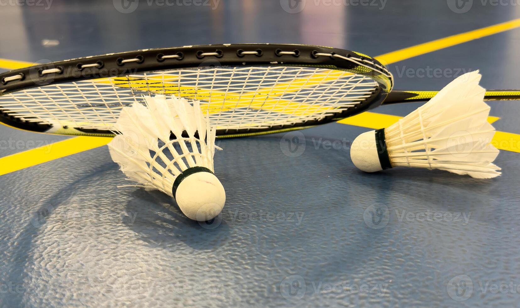 shuttlecock and badminton racket on the court photo