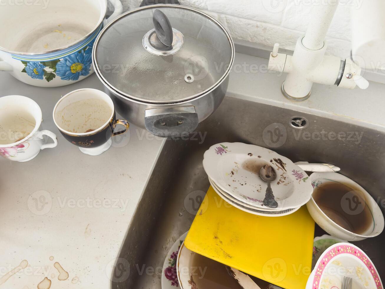 Many dirty dishes in kitchen matea sink. photo