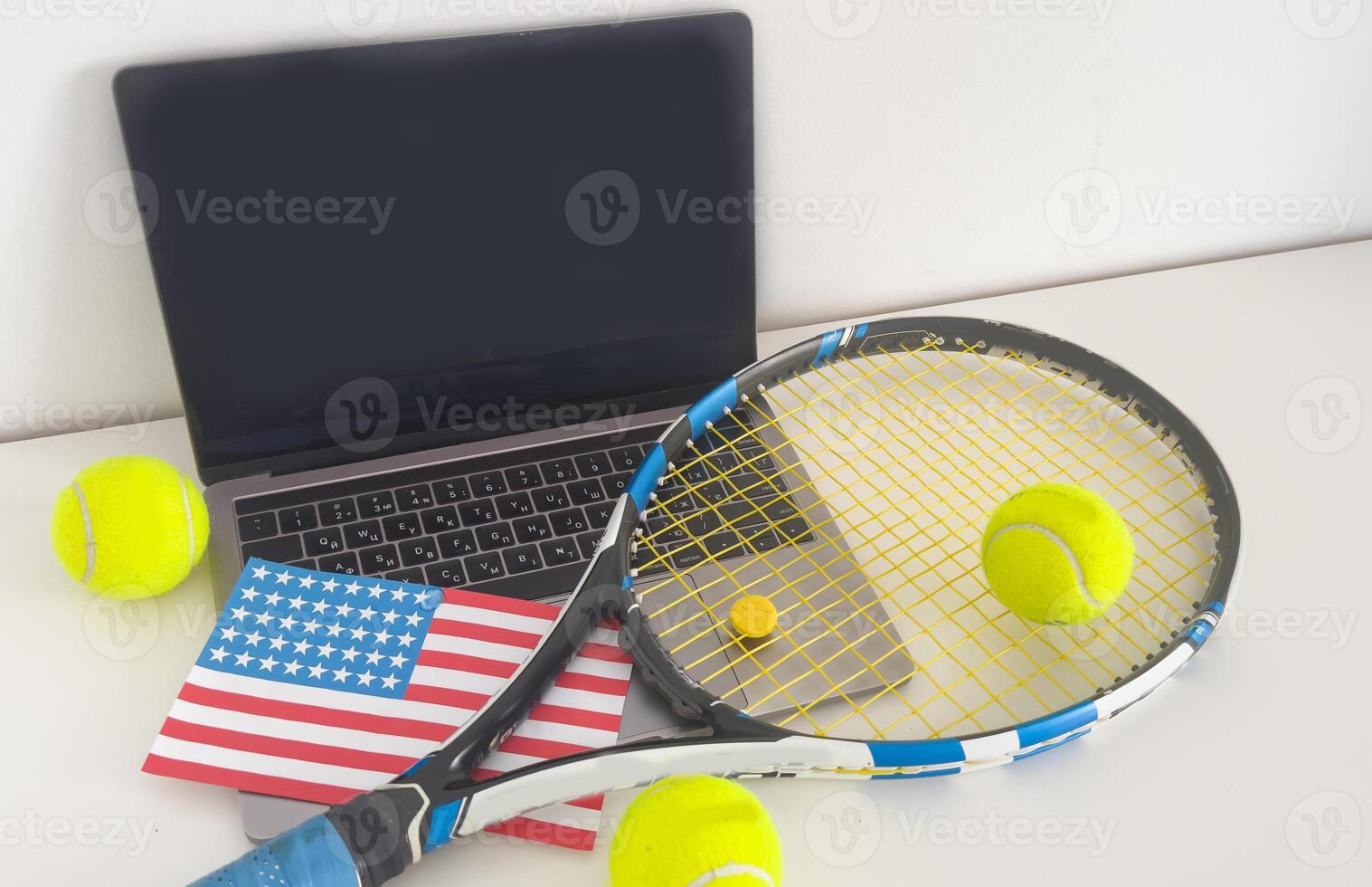 usa flag concept with tennis racket and laptop on top view. photo