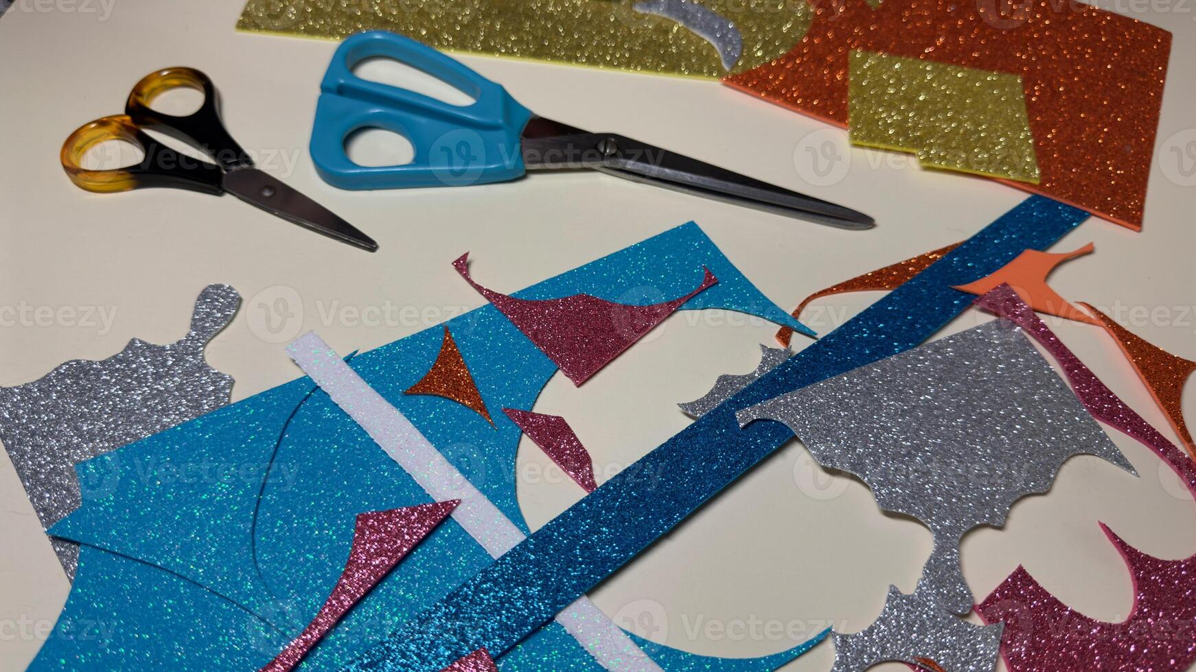 Table with cut pieces of foamiran sheets for crafts. photo