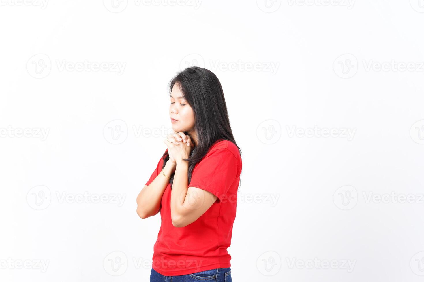 Folding hand closed eyes and praying Of Beautiful Asian Woman wearing red Isolated On White Background photo