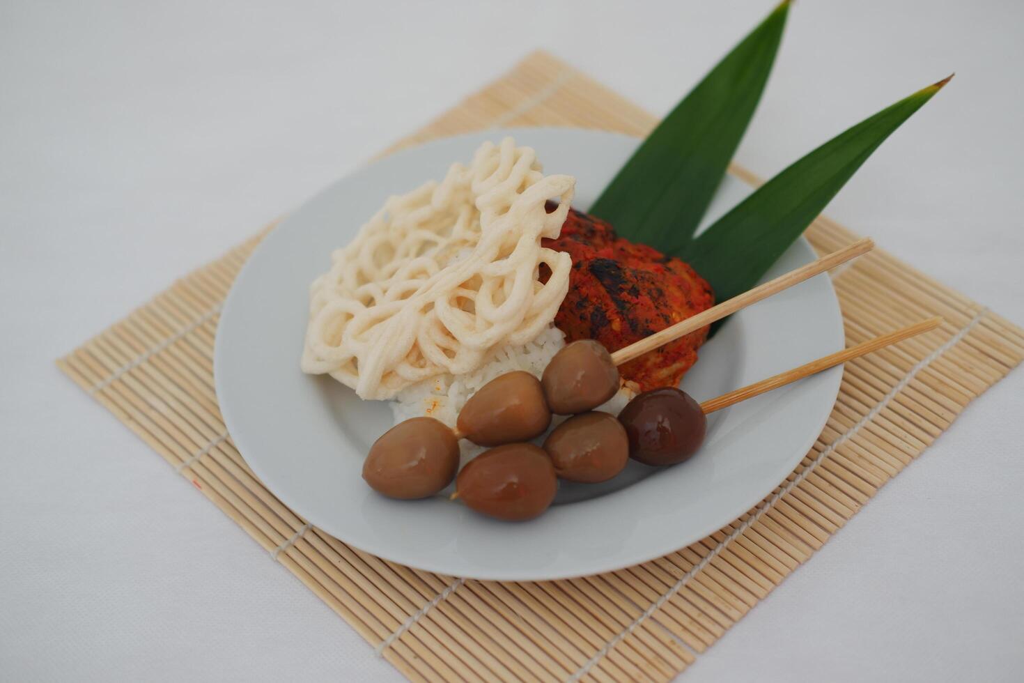 rice with skewered quail eggs and crackers on wood background. Selective focus. photo