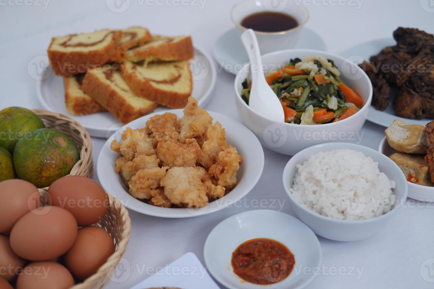traditional Indonesian food arranged neatly on a white surface photo