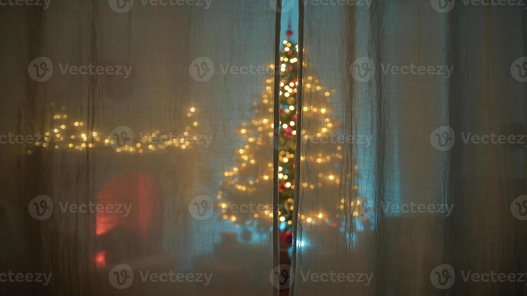 From The Curtain Of A House You Can See The Christmas Tree Lit Up at night photo