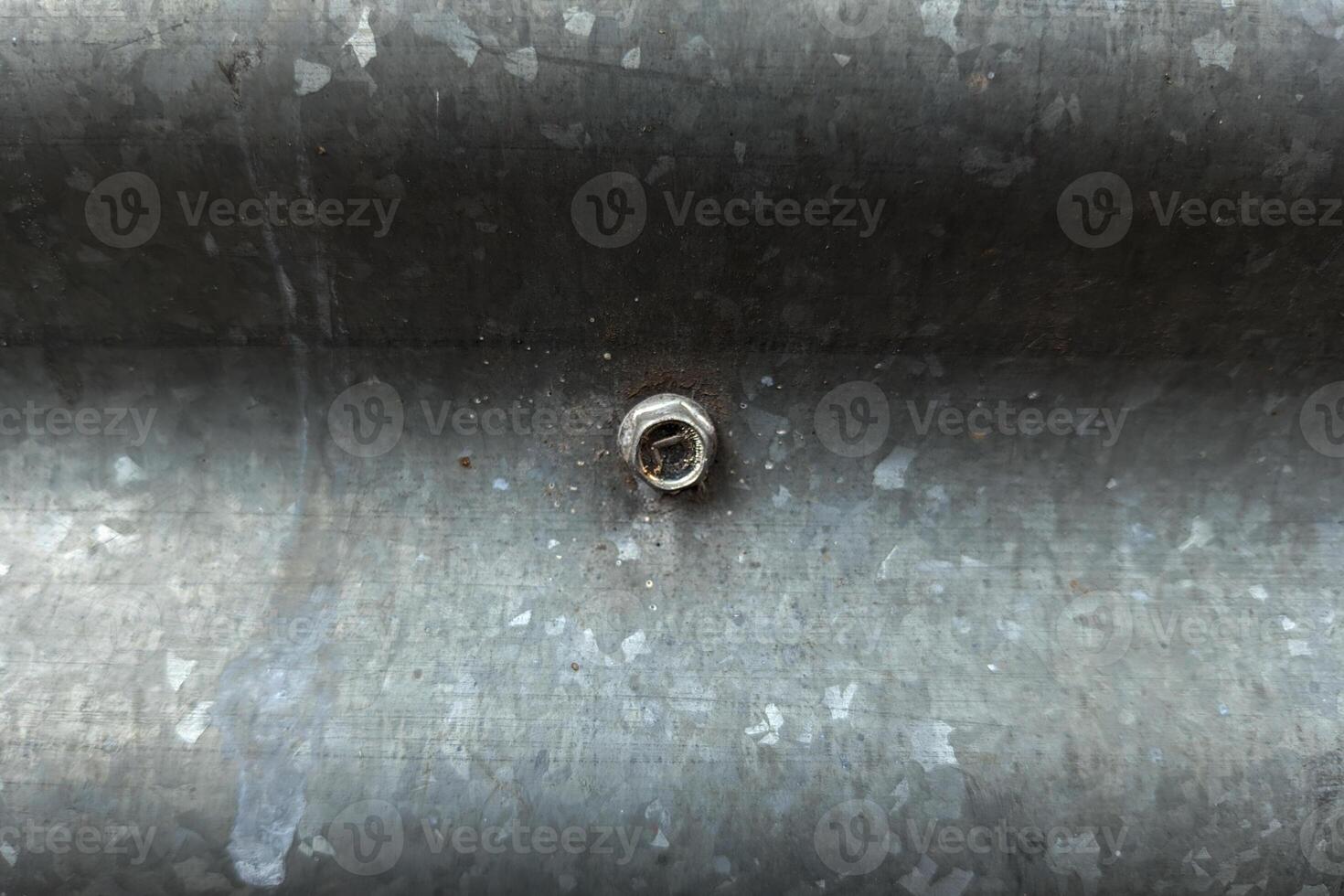 Close Up Of A Weathered Galvanized Metal Surface With A Bolt photo