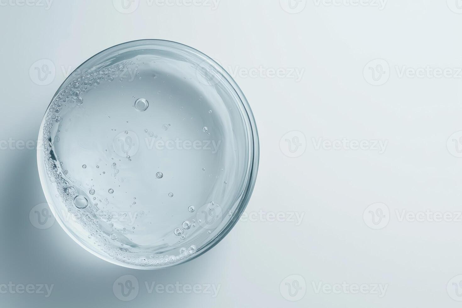 Transparent gel with bubbles in glass bowl photo