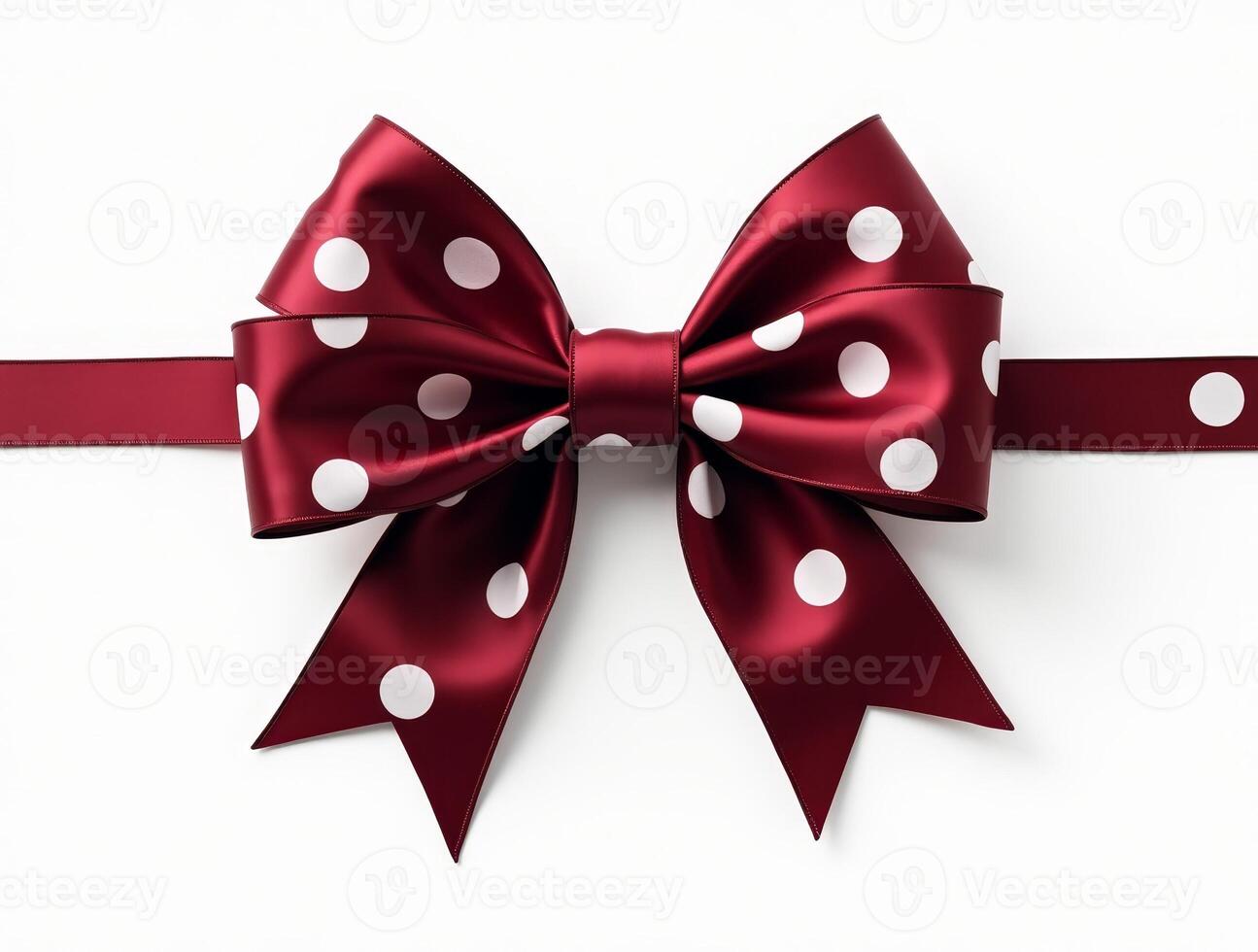 Dark red satin ribbon bow with white polka dots and long tails on a white background. Isolated decorative element for gift wrapping and design projects photo