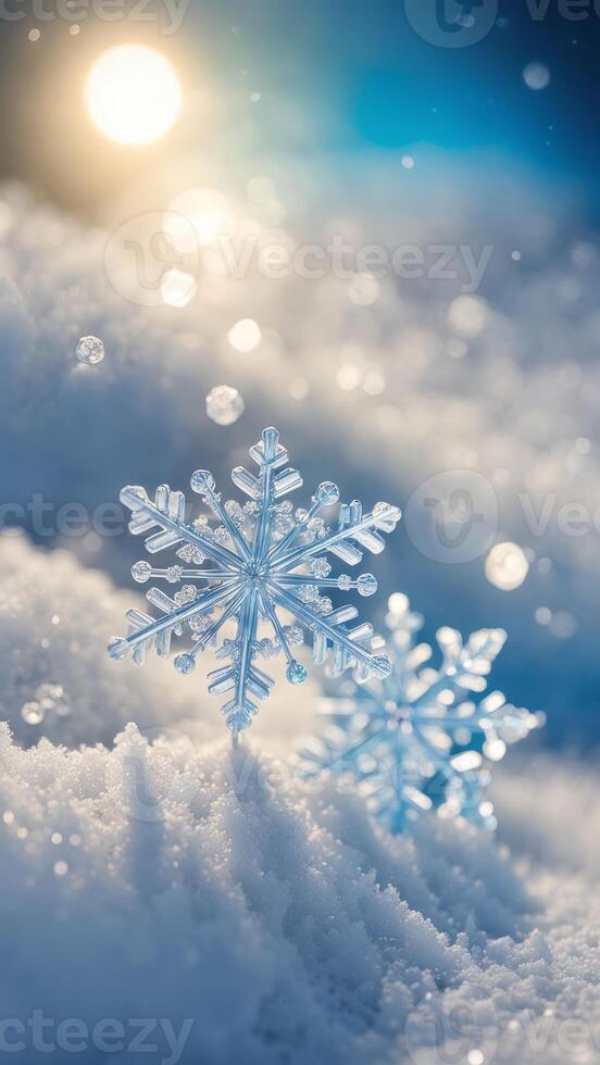 Close-up of two crystal snowflakes on a snowy surface with sunlight and bokeh background. Winter and Christmas concept photo