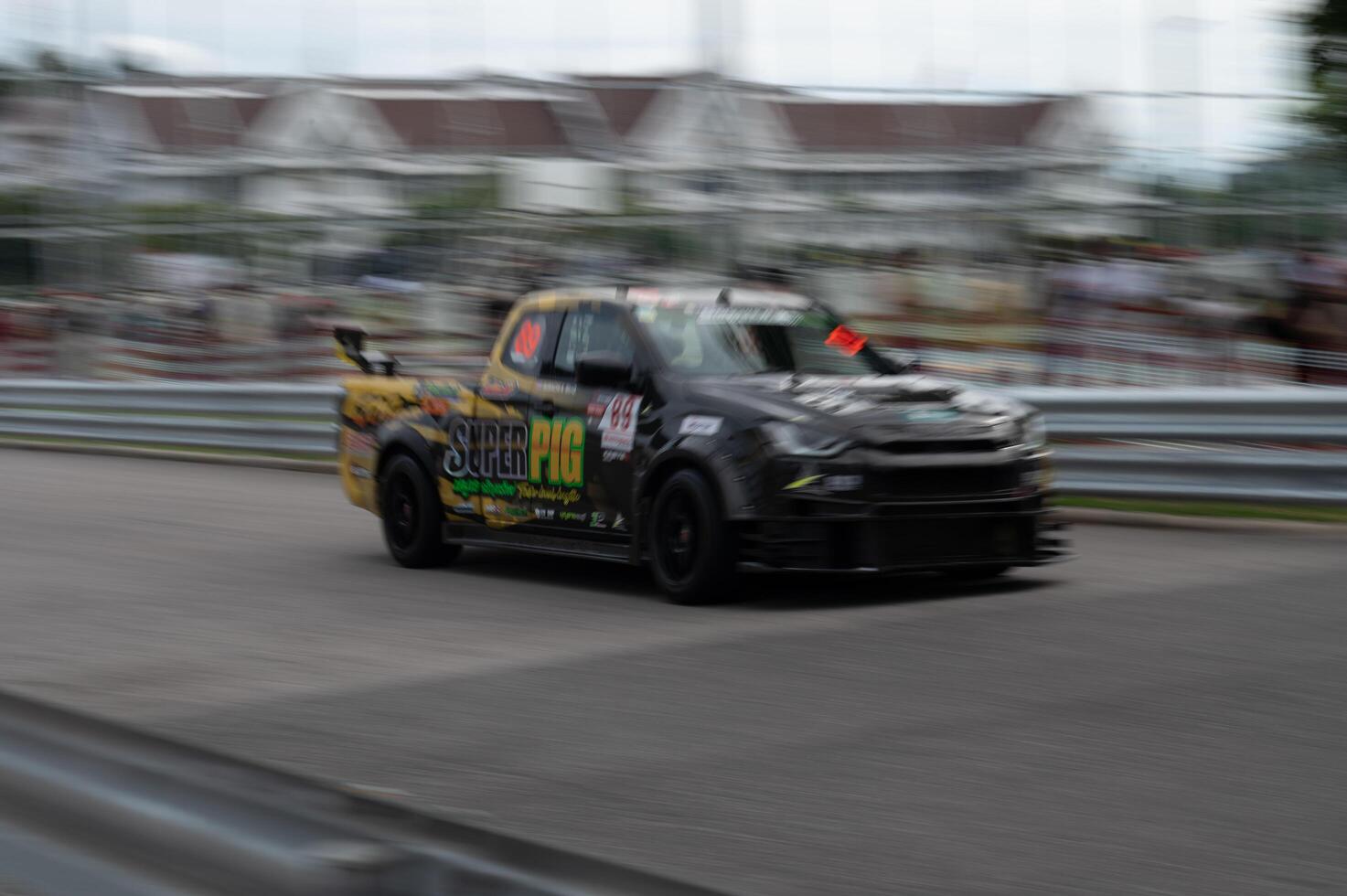 Songkhla, Moung, Thailand Oct 19, 2024 PT Maxnitron Motorsport, Capture thrill of motorsport with dynamic image of high-speed racing car, expertly navigating track photo