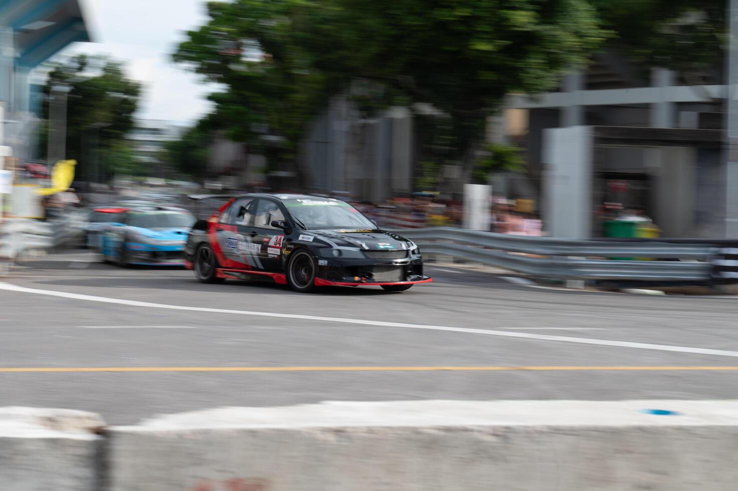 Songkhla, Moung, Thailand Oct 19, 2024 PT Maxnitron Motorsport, Dynamic shot of sleek racing car speeding through street circuit, adrenaline of motorsport Perfect for automotive photo