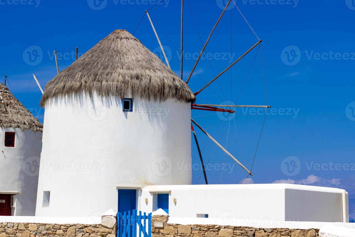 Traditional Greek windmills on Mykonos island under cloudy sky. Aerial view of iconic Mykonos windmills in Cyclades, Greece. photo