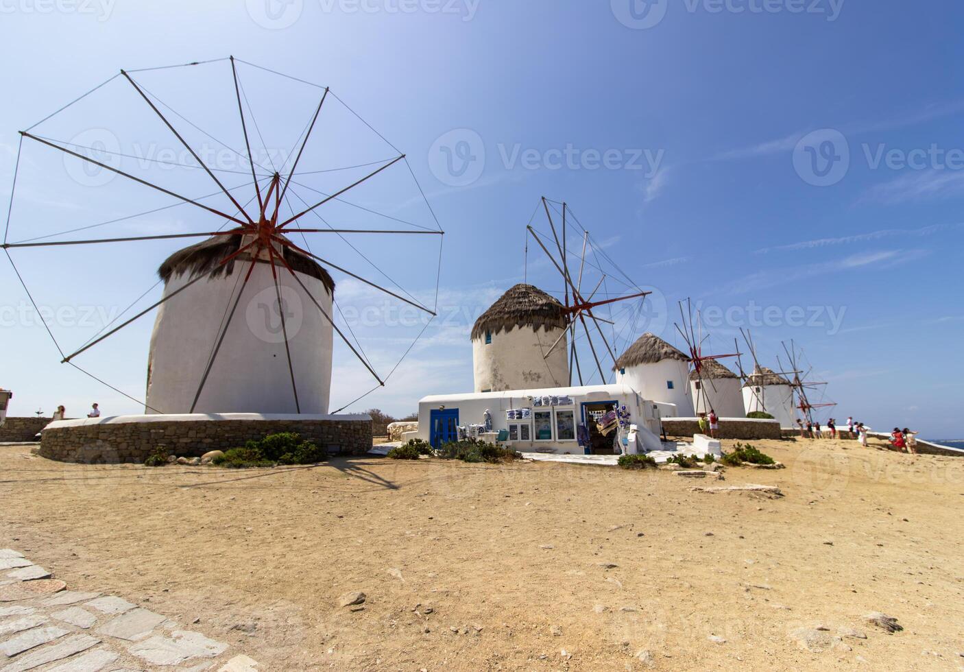 Traditional Greek windmills on Mykonos island under cloudy sky. Aerial view of iconic Mykonos windmills in Cyclades, Greece. photo