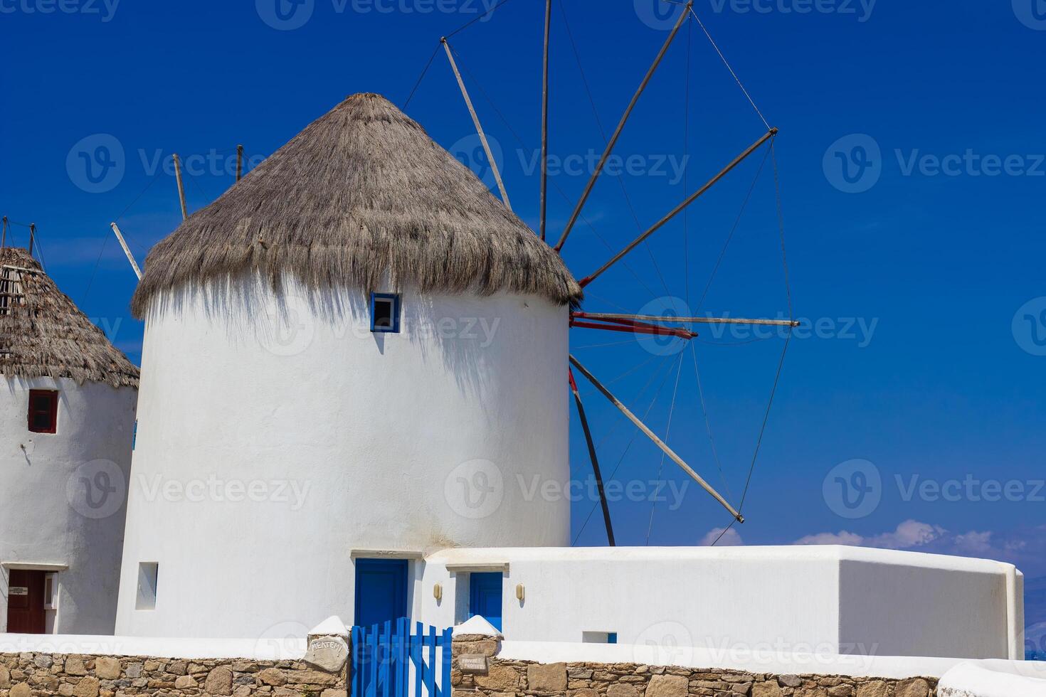 Traditional Greek windmills on Mykonos island under cloudy sky. Aerial view of iconic Mykonos windmills in Cyclades, Greece. photo