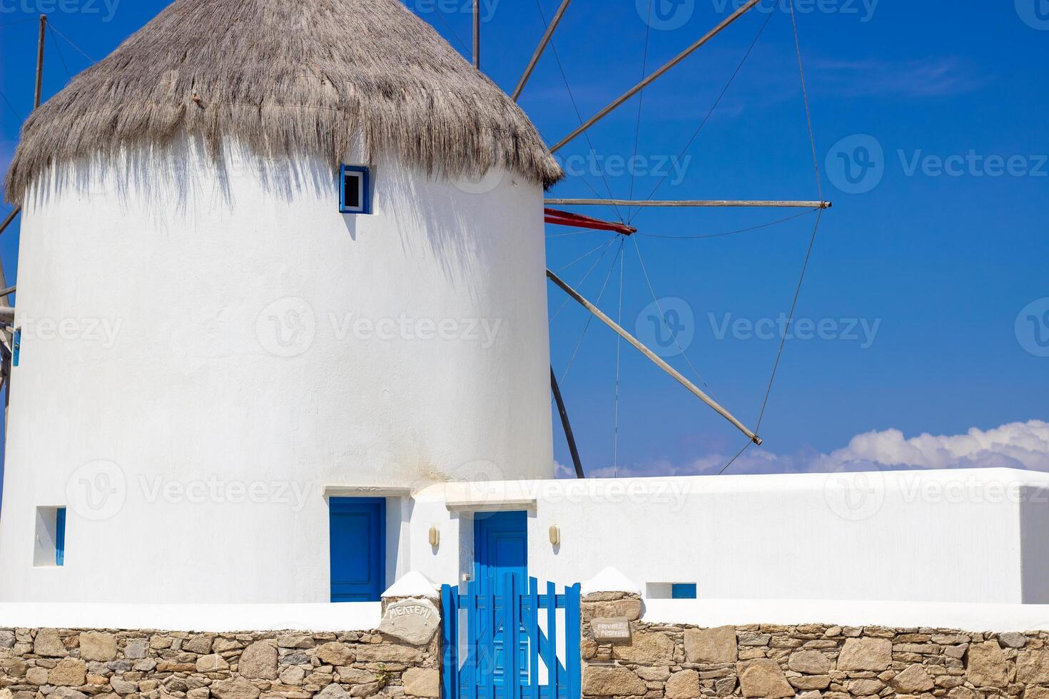 Traditional Greek windmills on Mykonos island under cloudy sky. Aerial view of iconic Mykonos windmills in Cyclades, Greece. photo