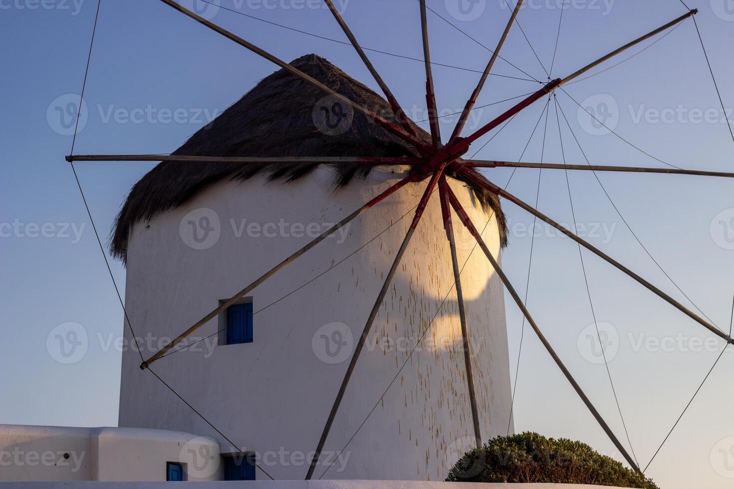 Traditional Greek windmills on Mykonos island under cloudy sky. Aerial view of iconic Mykonos windmills in Cyclades, Greece. photo