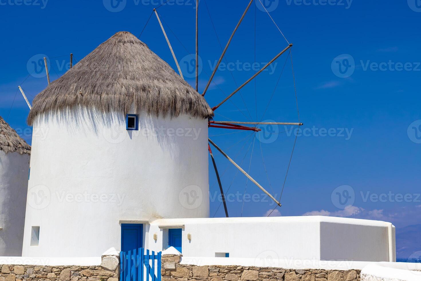 Traditional Greek windmills on Mykonos island under cloudy sky. Aerial view of iconic Mykonos windmills in Cyclades, Greece. photo