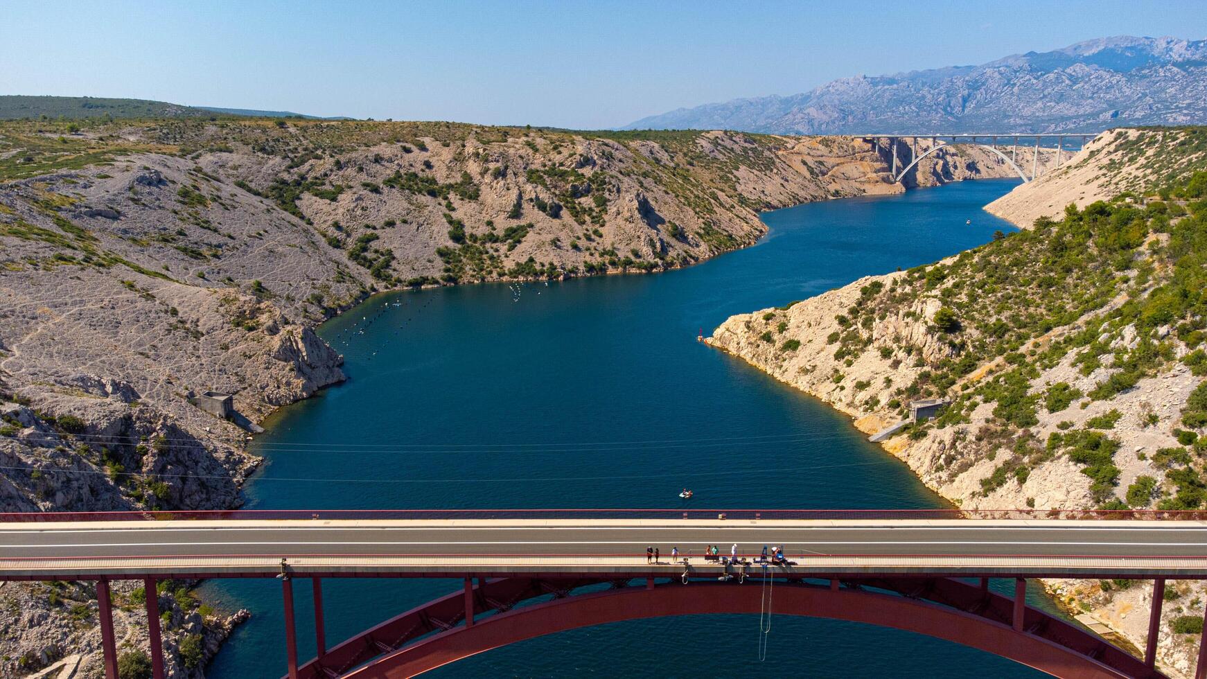 two bridges crossing a waterway, a fjord. Aerial view Maslenica bridge, arch bridge for car trip in Croatia. photo