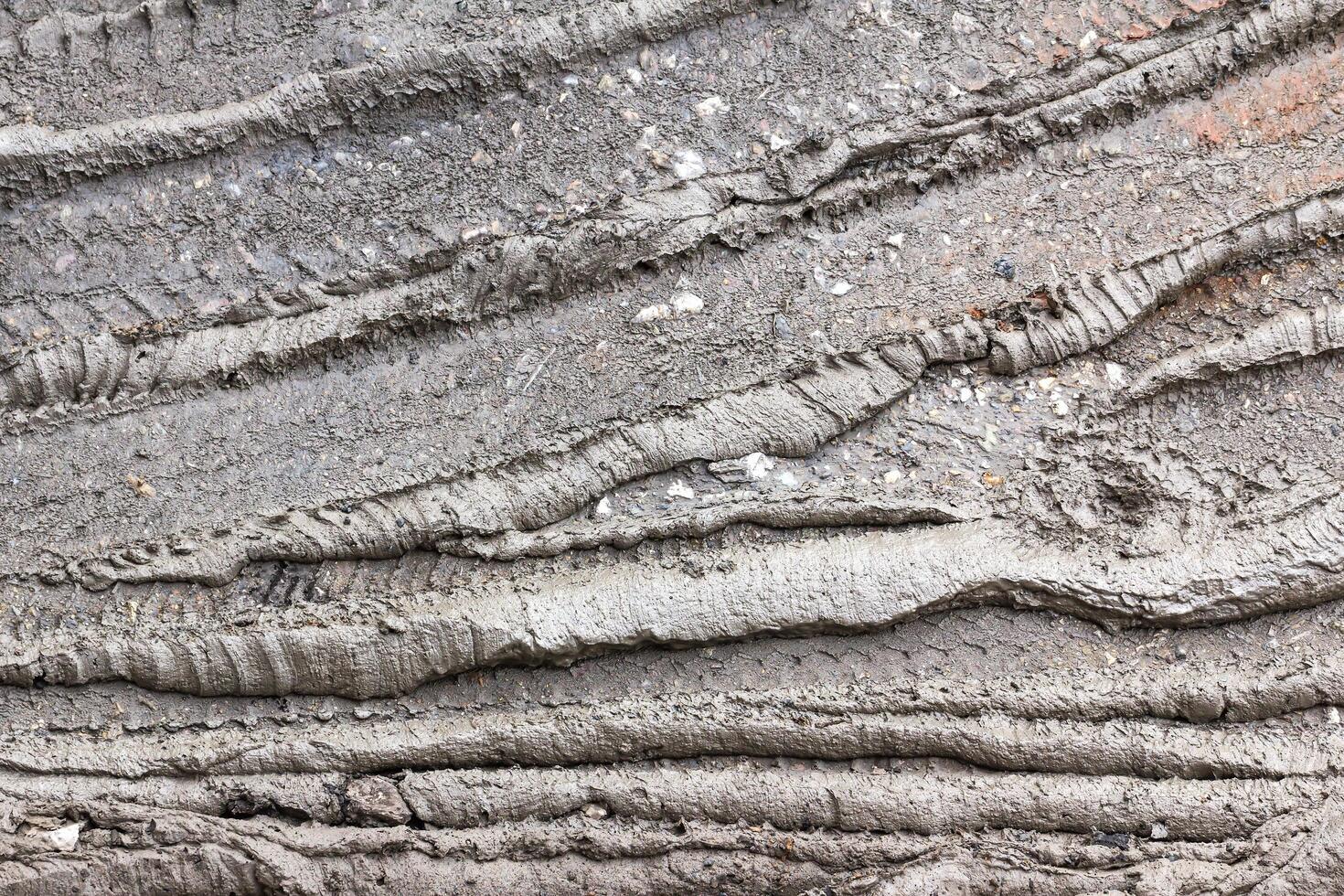 A close up of a wall with a lot of cracks photo