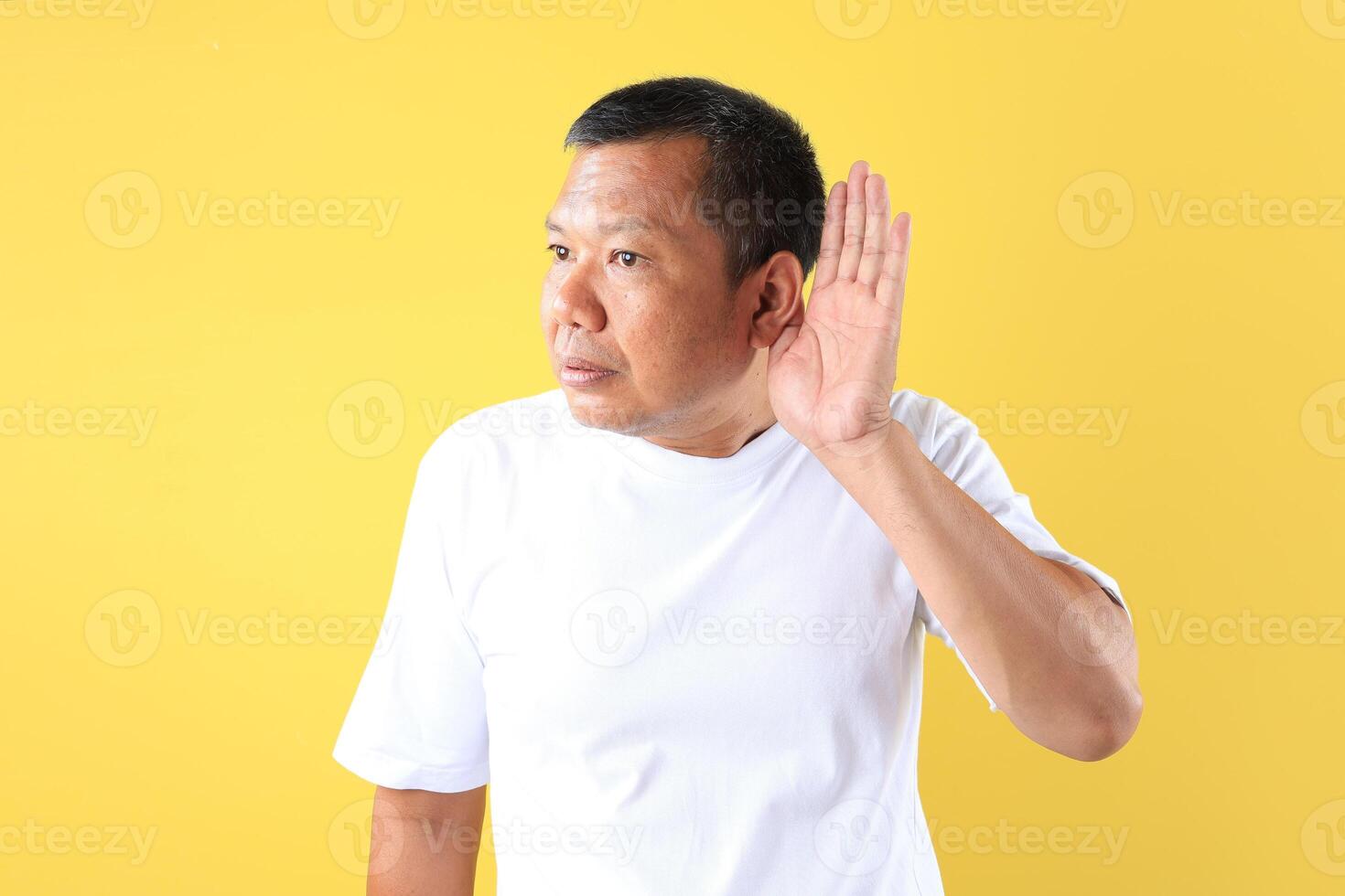 Asian Middle Age Man with Hand on His Ear, Having Bad News or Lack of Hearing Concept photo