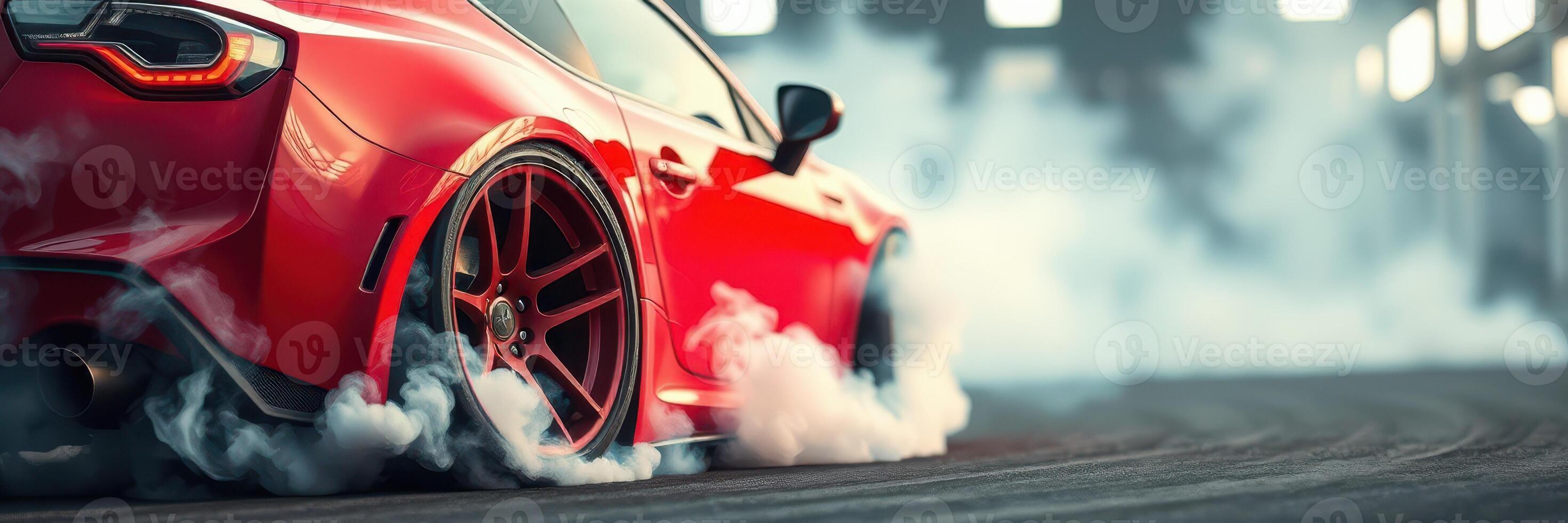Red sports car performs a burnout in a dimly lit automotive workshop during evening hours photo