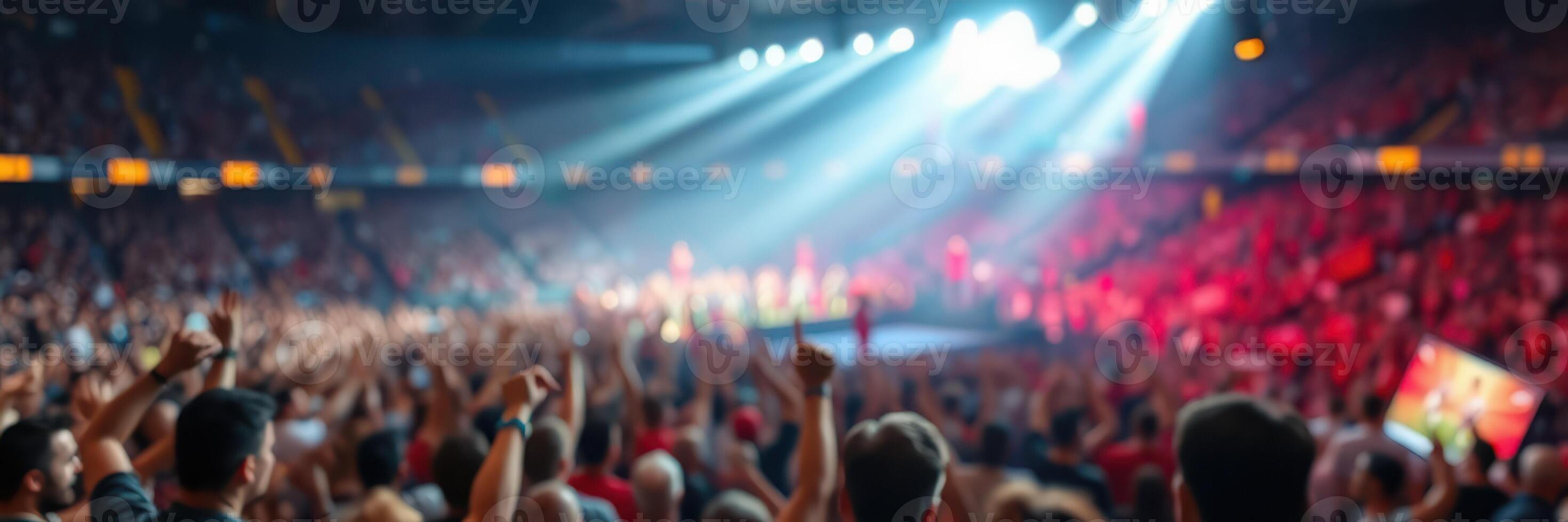 Energetic crowd enjoying a live concert at an indoor arena with vibrant lights and sounds photo