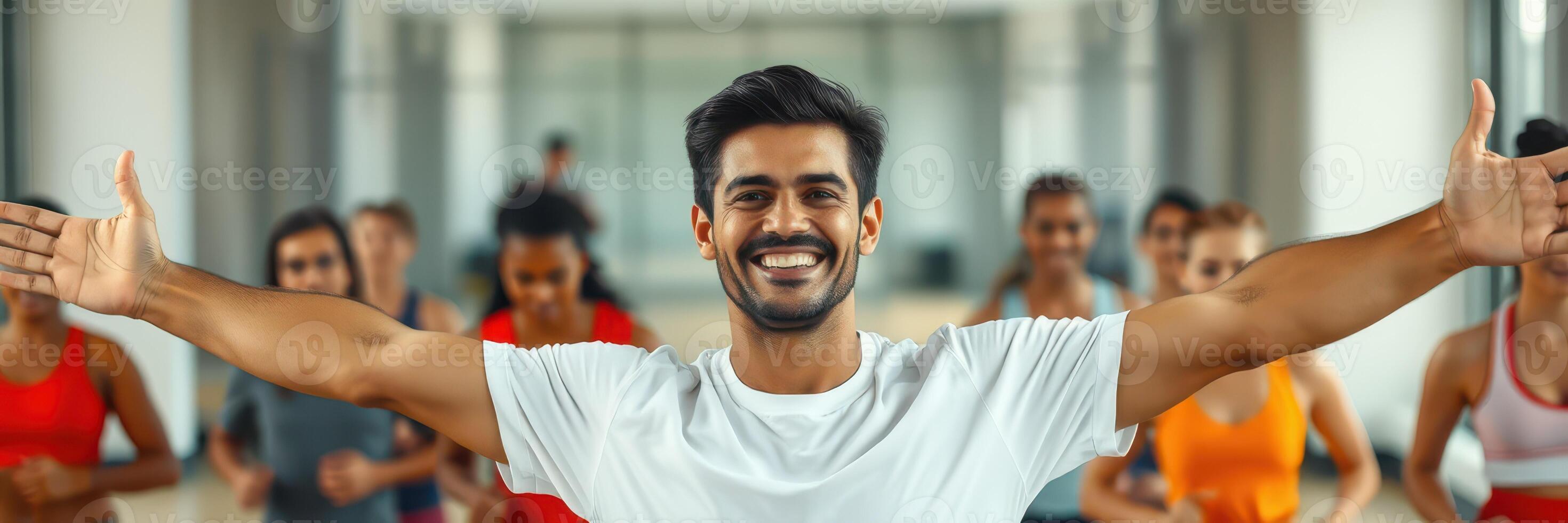 Group fitness class led by an enthusiastic instructor in a gym setting during daytime photo