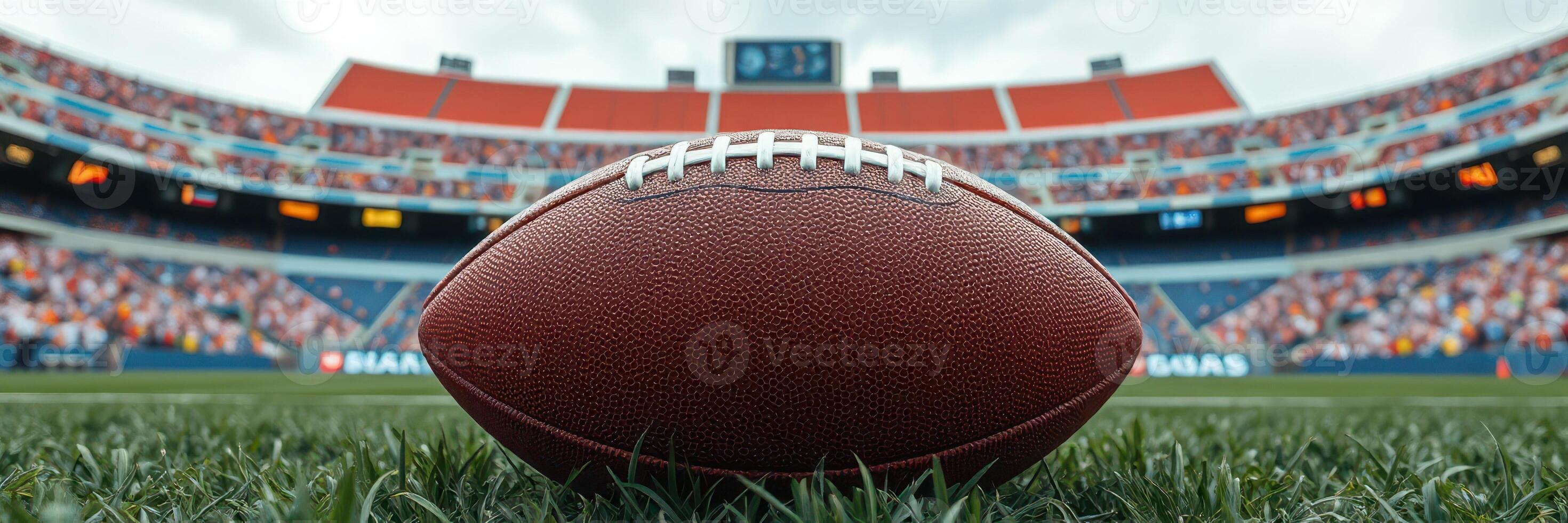Exciting moment as a football rests on the field during a game in a packed stadium on a sunny day photo