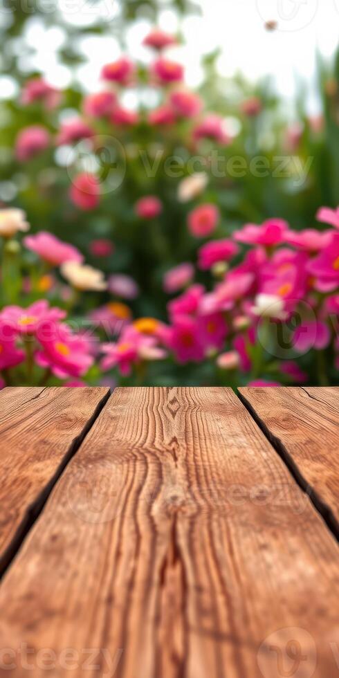 Beautiful garden blooms with wooden surface in foreground during a sunny day photo