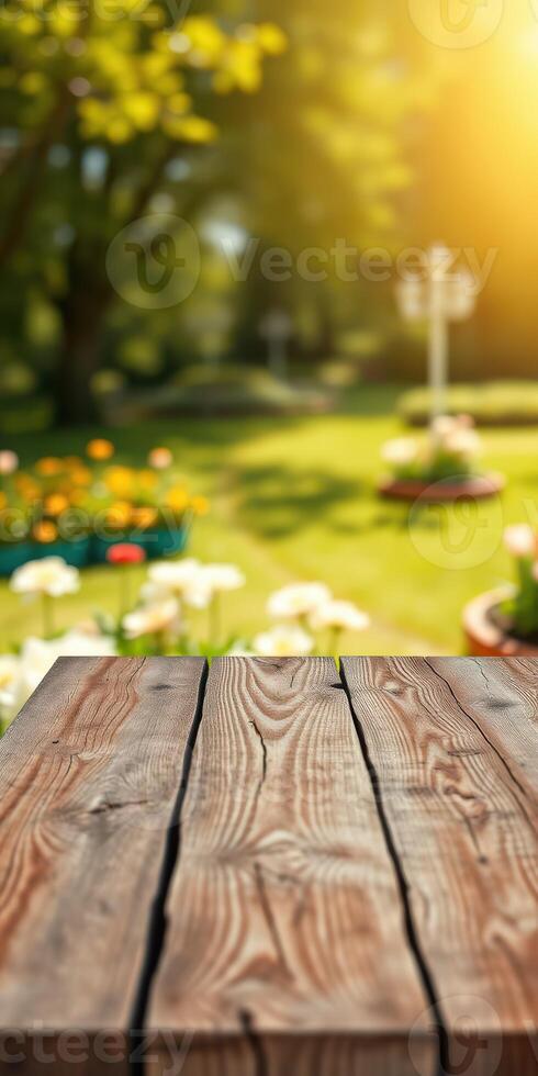 Wooden table in a sunny garden setting with blooming flowers and lush greenery during springtime photo
