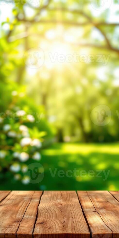 Sunlight filters through trees in a serene park filled with blooming flowers and a wooden table in the foreground photo