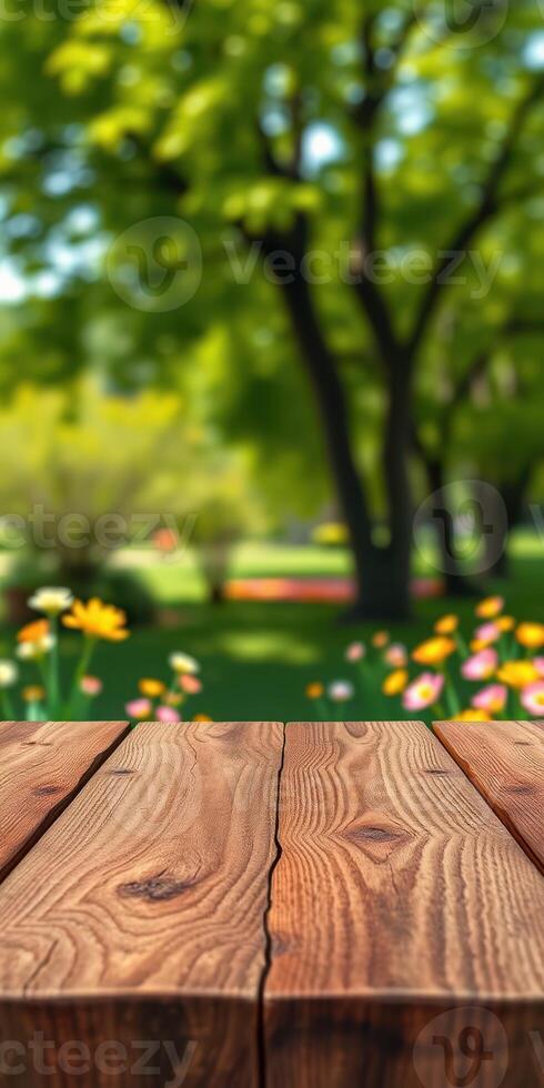 Wooden table in a vibrant garden full of blooming flowers under bright sunlight photo