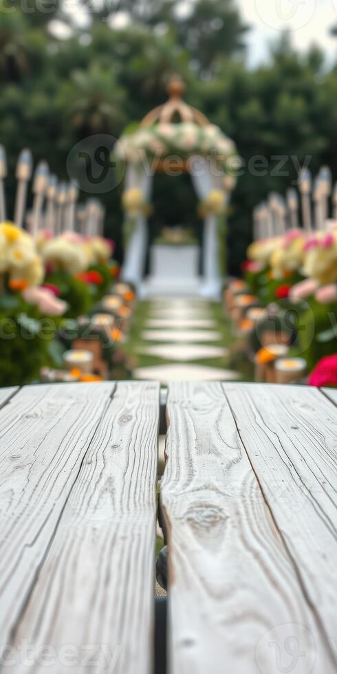Beautiful floral arrangements line the aisle leading to a decorated wedding altar in a serene outdoor setting photo