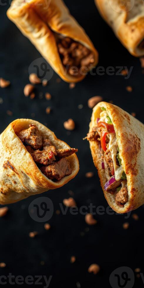 Delicious wraps filled with grilled meat and fresh vegetables on a black background showcasing vibrant colors and textures photo