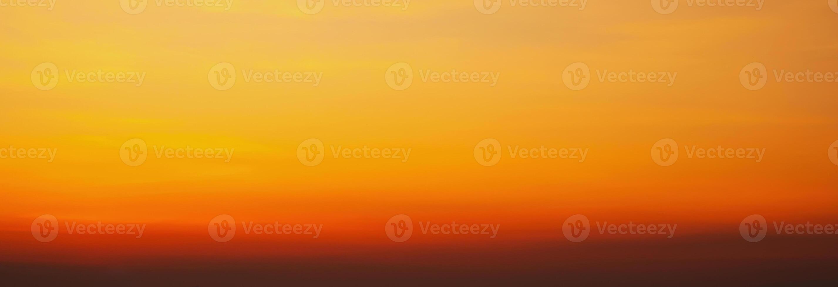Panorama with orange sunset in cloudy sky with clouds. Background with sky at sunrise photo