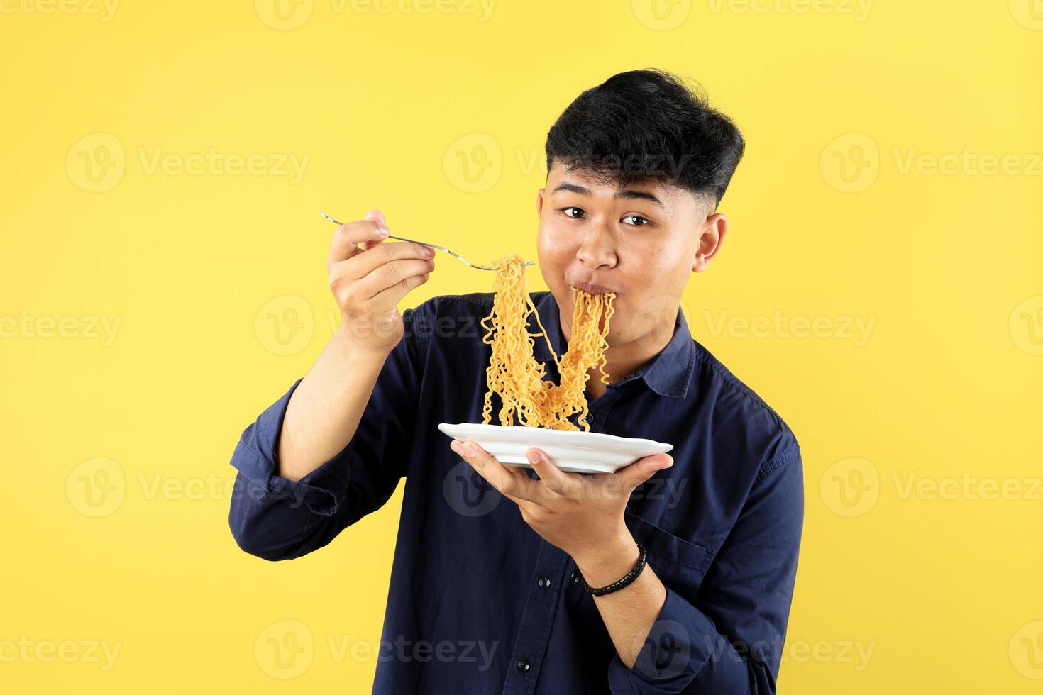 Young Asian Student Holding White Plate with Instant Fried Noodle photo
