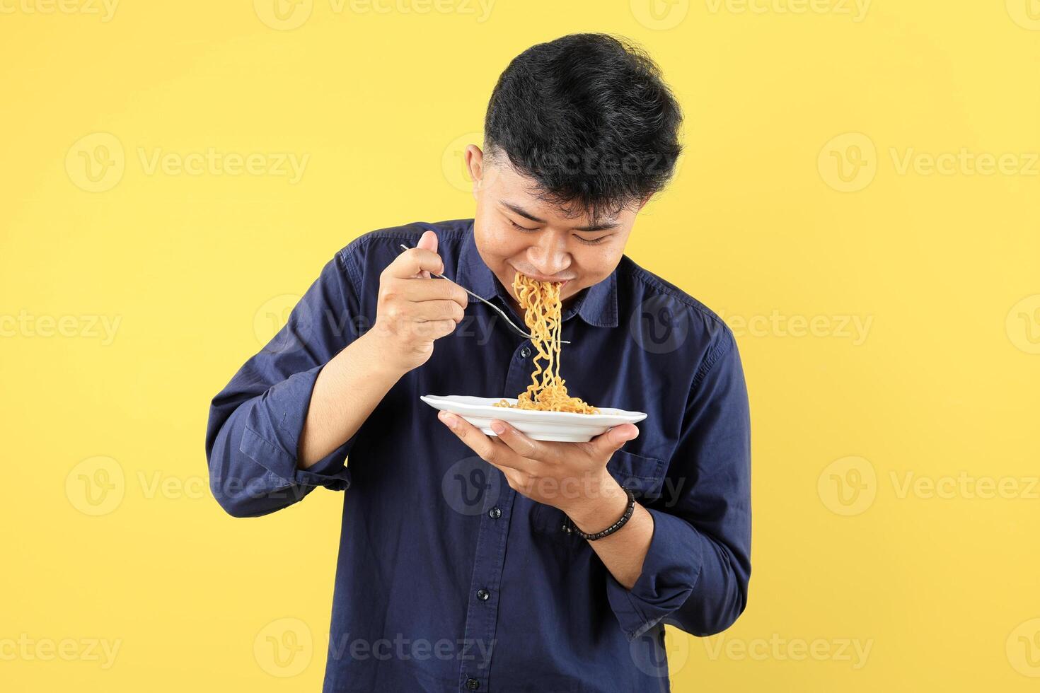Young Asian Man Enjoy Instant Noodles with Happy Face photo