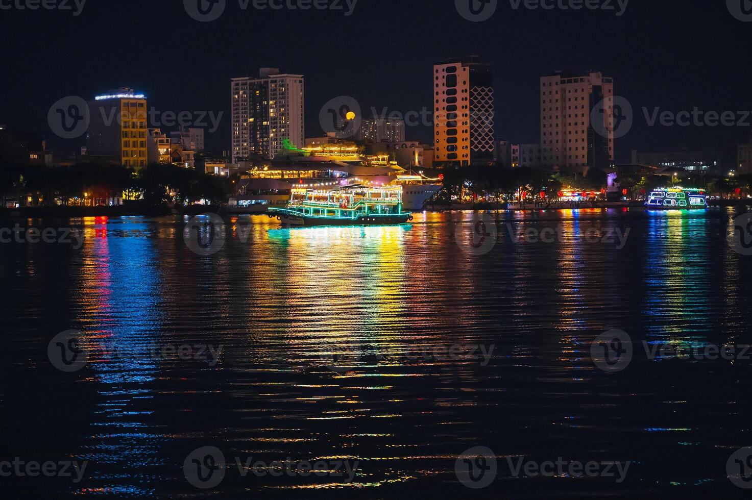 Night panorama of Han River embankment and skyscrapers in the center of Da Nang in Vietnam at night photo