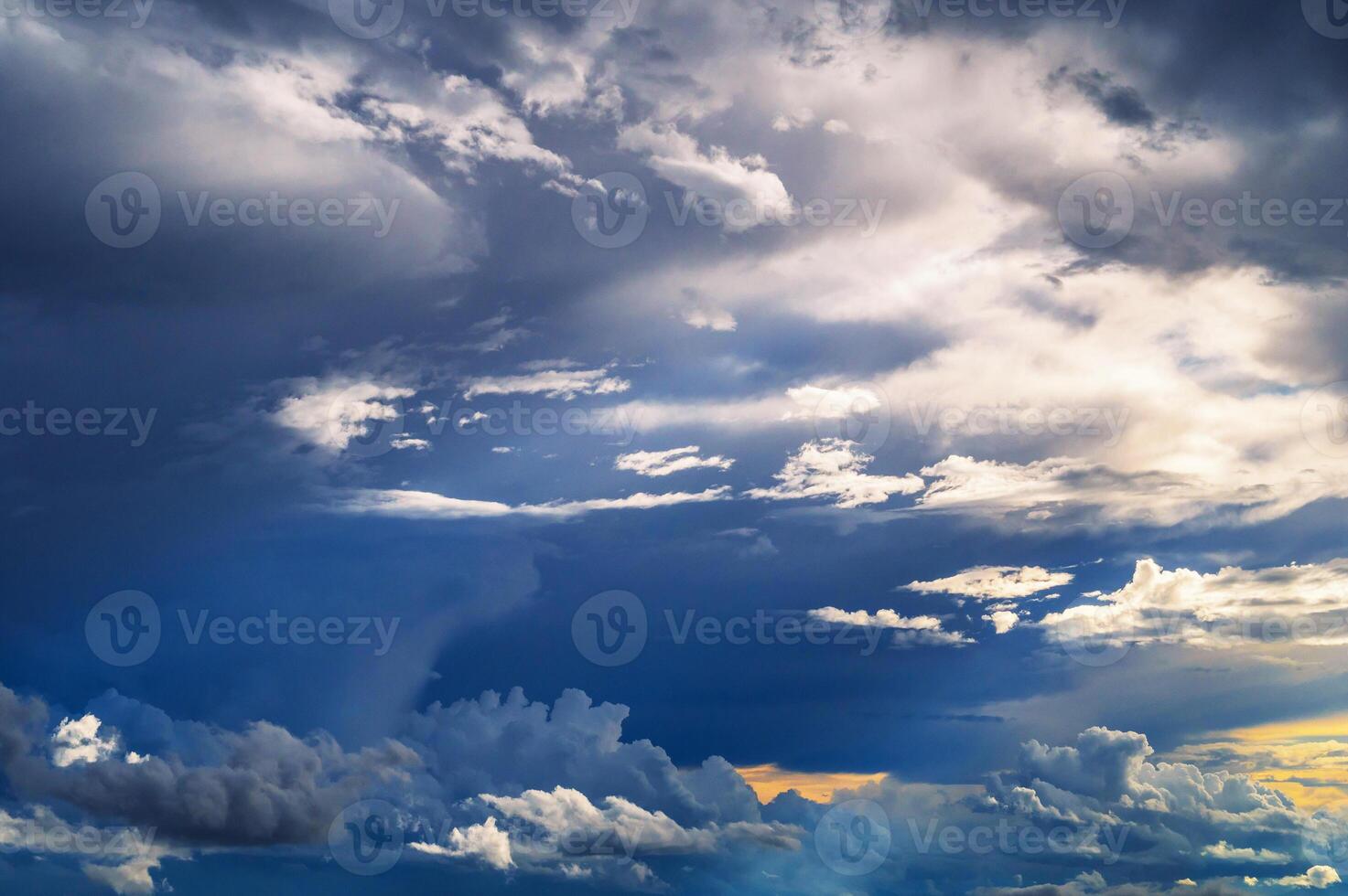 Dramatic blue cloudy sky with clouds at sunset in evening photo