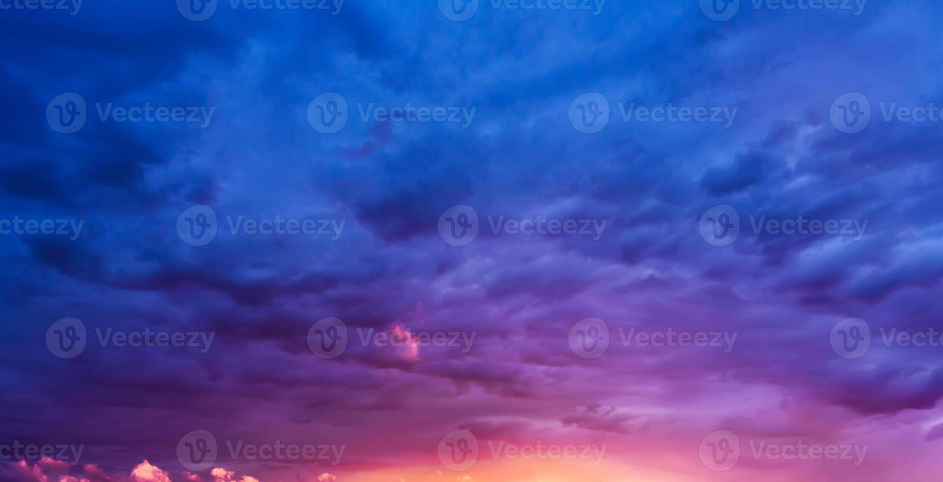 Background with purple clouds in cloudy blue sky at sunset in evening. Dramatic beautiful sky photo