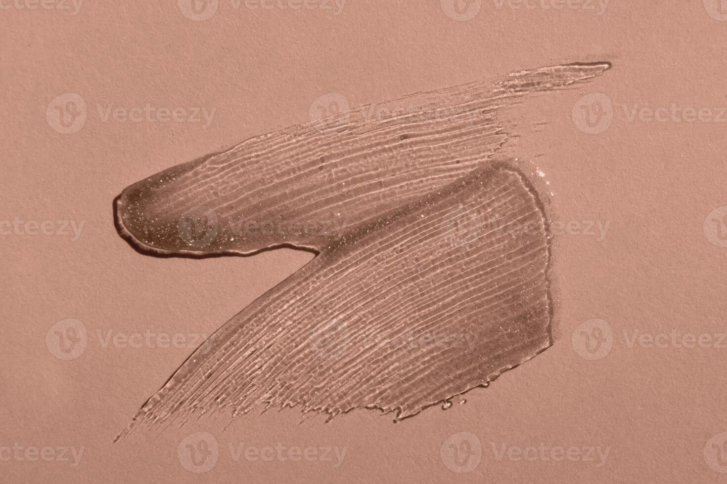 Smears of transparent shining lip gloss, mocha mousse tinting photo