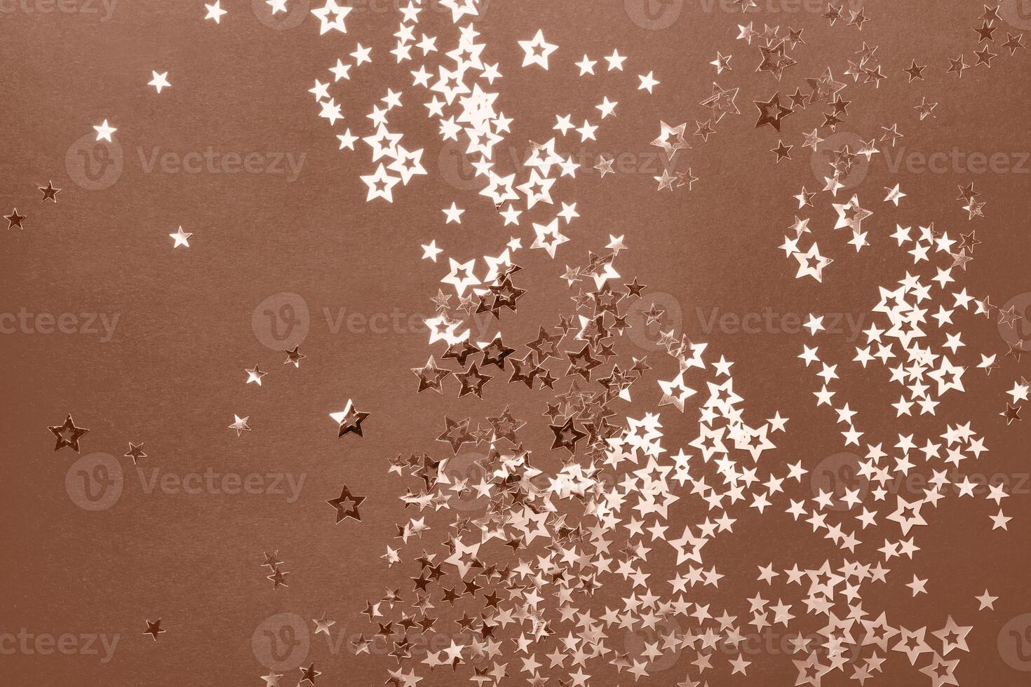 Christmas festive background in mocha mousse color with confetti stars photo