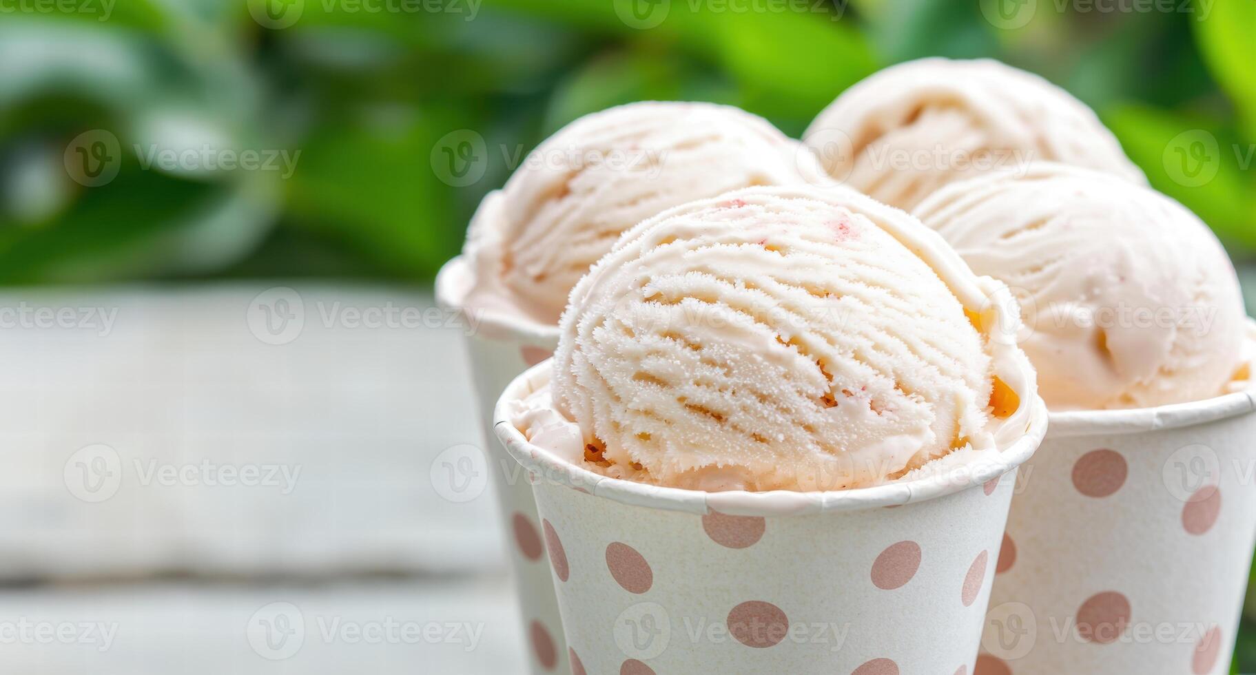 Delicious scoops of creamy ice cream in a polka dot cup photo