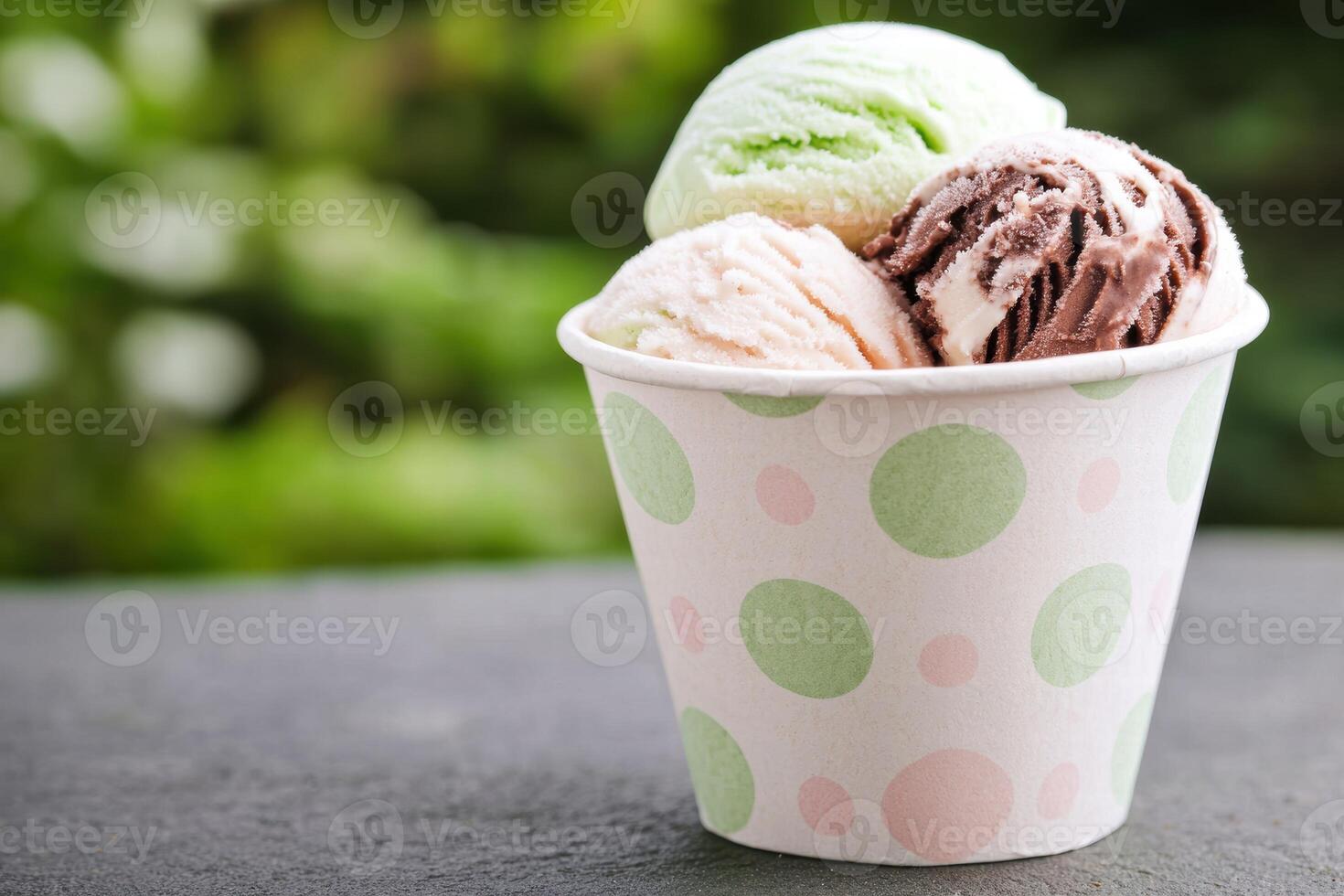 Colorful ice cream scoops in a polka dot cup photo