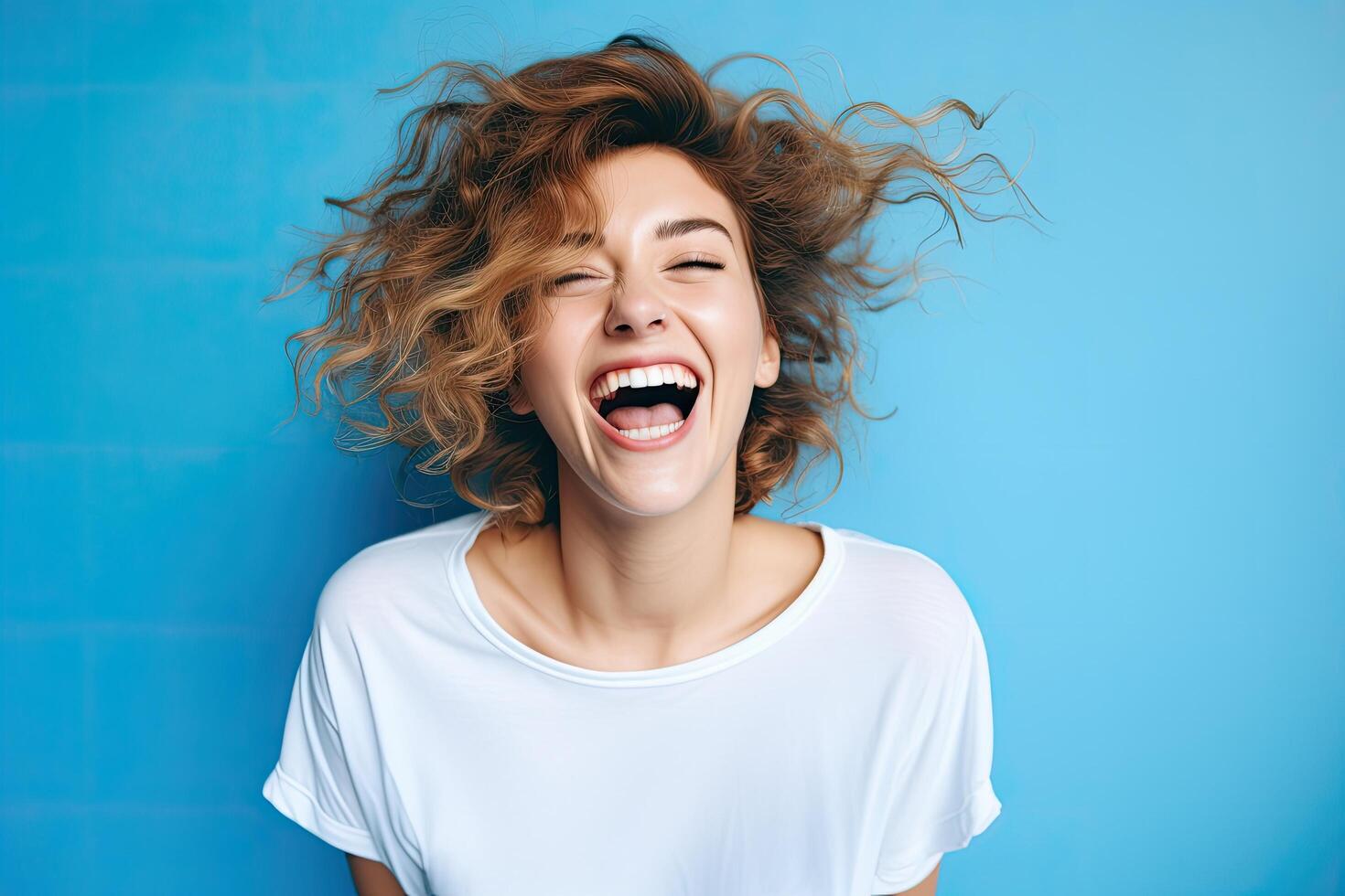 joyful woman with curly hair laughing photo
