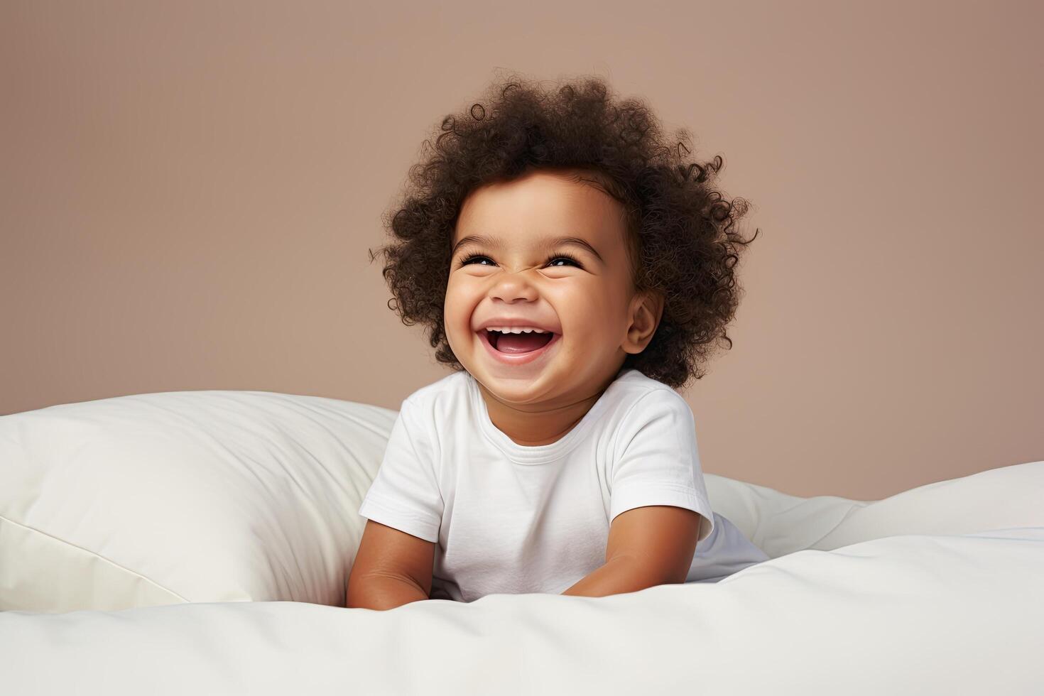 Joyful young child with curly hair laughing photo
